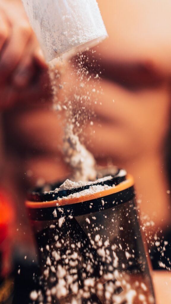 How I Tracked Protein to Gain 10kg person drinking protein shake gym